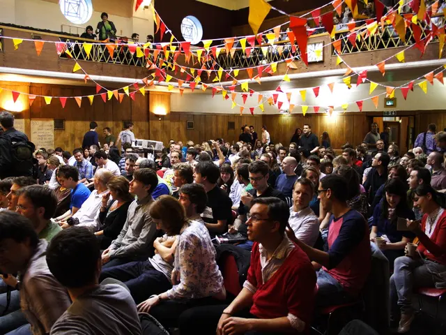 In this image, we can see people wearing clothes. There are lights on the wall. There is a...