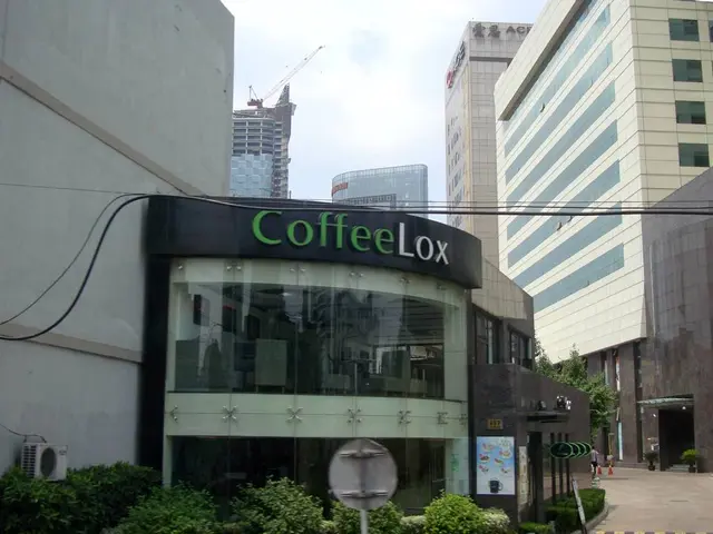 In the image there is a commercial building and in front of that there are few plants and there are...